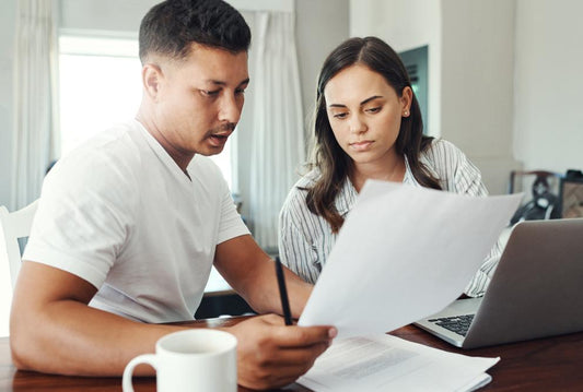 Couple evaluating personal budgets and credit