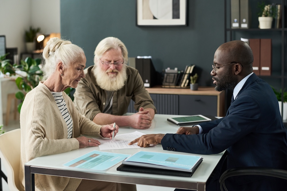 senior woman and couple reviewing documentation