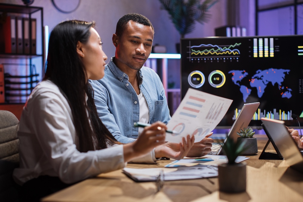 Two business people discussing financial trends