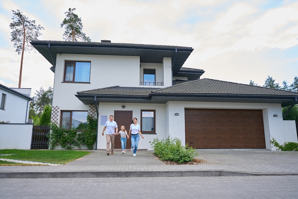 A happy family stepping out of their new home