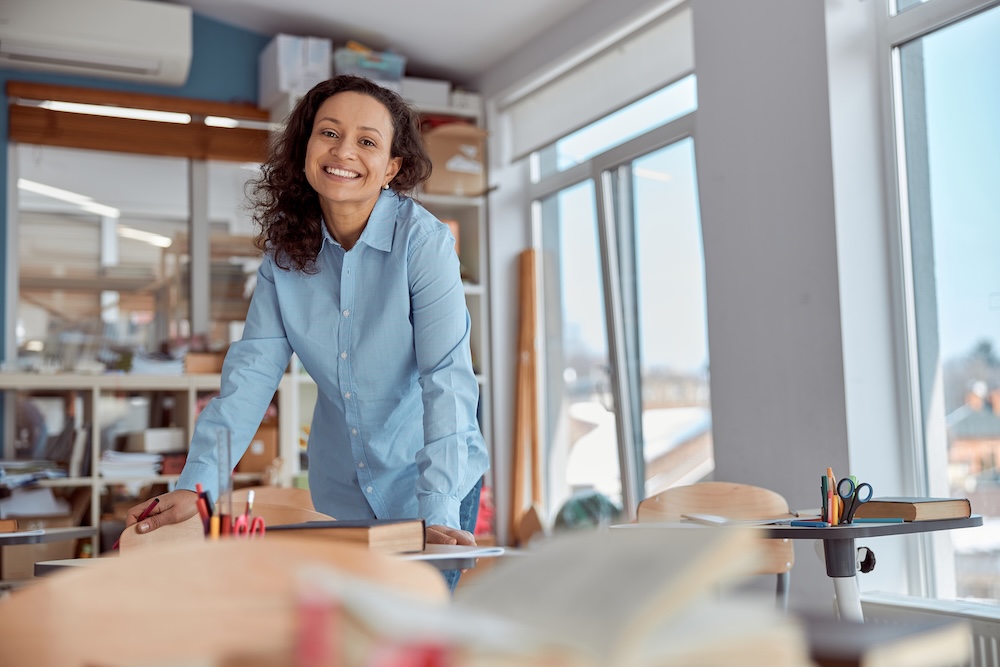 Woman alone in her office smiling