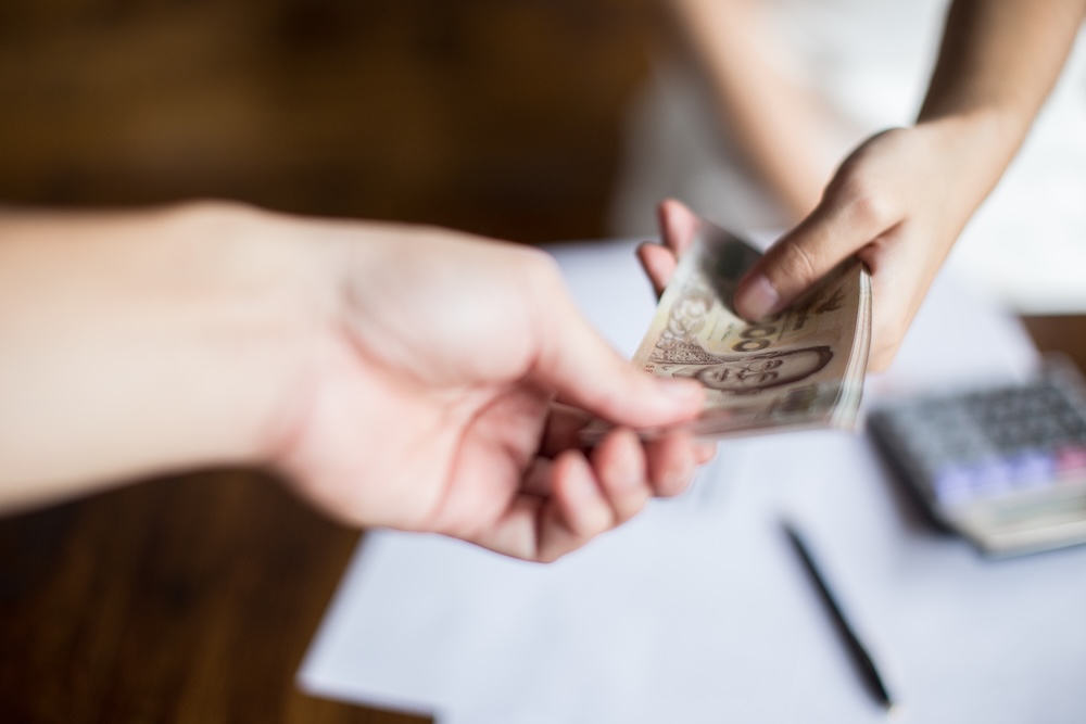 People exchanging cash in hand
