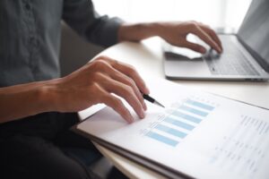 Close up of a woman tracking her financials on a laptop