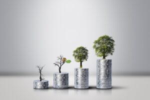 stacked coins with trees growing out of the top