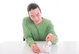 College student saving money in a piggy bank