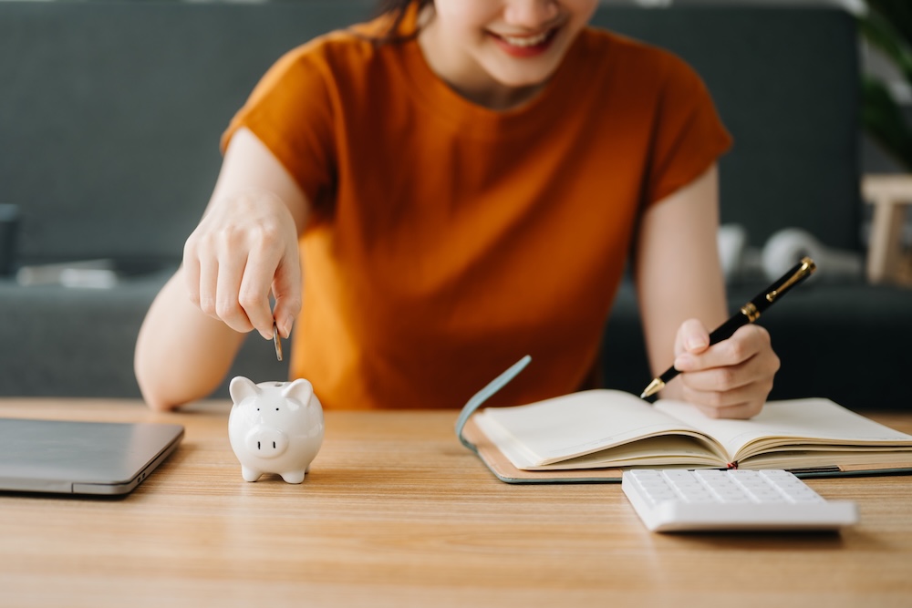 Young student calculating savings