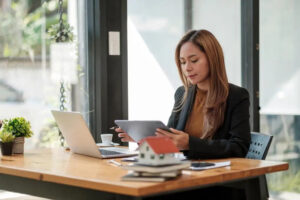 Woman working at her desk using her tablet