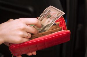 woman holding purse taking out money