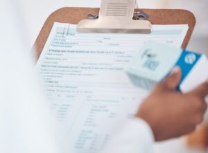 pharmacist holding prescription looking at copay