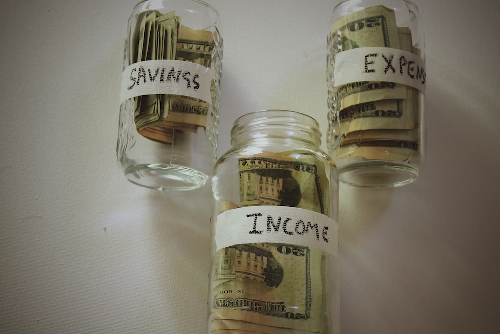 savings income and expenses in a jar