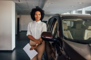 Sales woman holding auto-financing paperwork
