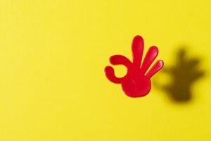Small plastic hand making OK sign