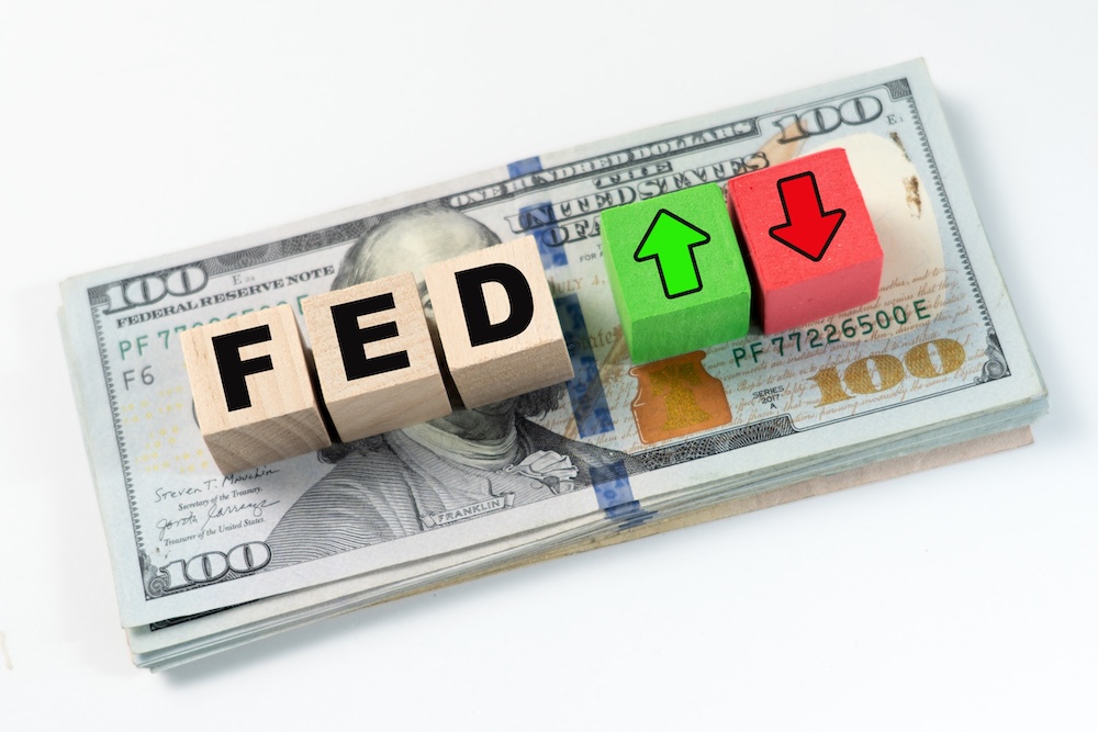 Money with wooden words FED with green and red arrows